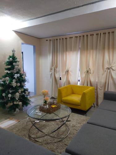 a living room with a yellow couch and a christmas tree at 4 bedroom 2 bath house in Angeles