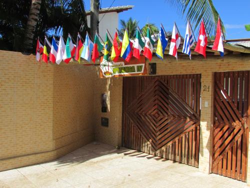 a bunch of flags are hanging over a gate at Pousada Ipitanga IV in Lauro de Freitas