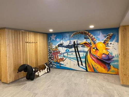 a room with a mural of a goat on the wall at Chalet Jardin Alpin Valberg in Péone