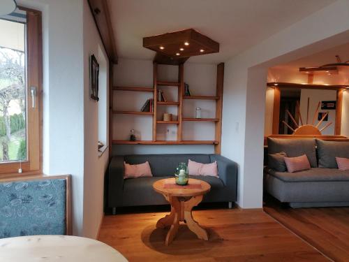 a living room with a couch and a table at Haus Alpenglühn in Abtenau