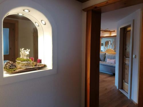 a mirror on a wall next to a living room at Haus Alpenglühn in Abtenau