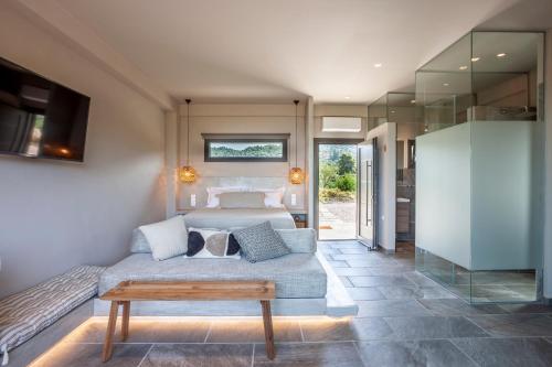 a bedroom with a bed and a table at Alterra Vita Eco Villas in Neos Marmaras