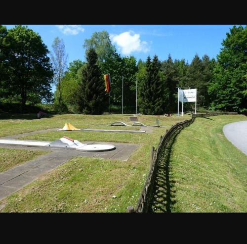 a model of a plane sitting on the side of a road at Neues-Ferienhaus-am-schoenen-Ferienpark-Twistesee-Naehe-Bad-Arolsen in Bad Arolsen