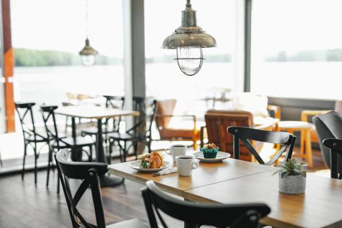 a table and chairs in a restaurant with a meal at Holiday Club Saimaan Rauha in Imatra