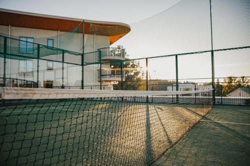 a tennis court with a net in front of a building at Holiday Club Saimaan Rauha in Imatra