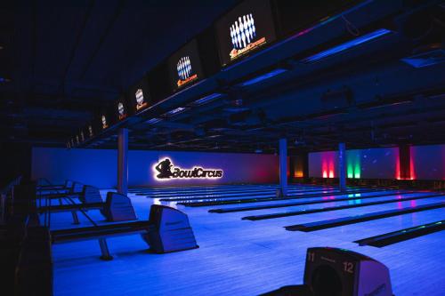 a bowling alley with rows of pins and neon signs at Holiday Club Saimaan Rauha in Imatra