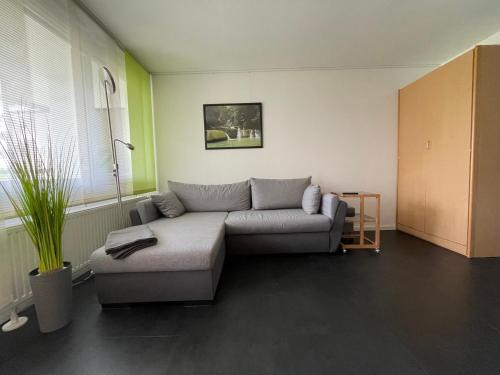 a living room with a couch and a table at Studio "Auszeit wie dahoam" im Predigtstuhl Resort in Sankt Englmar