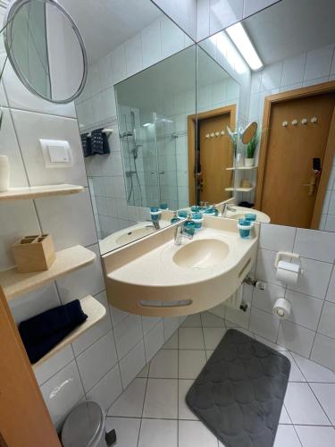 a bathroom with a sink and a mirror at Ferienapartment Auszeit wie dahoam Am Predigtstuhl in Sankt Englmar