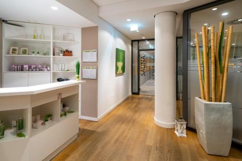 a store hallway with wooden floors and white shelves at INNSiDE by Meliá Dresden in Dresden