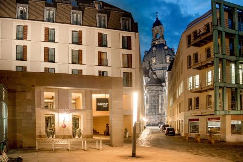 a city street with buildings and a clock tower at INNSiDE by Meliá Dresden in Dresden