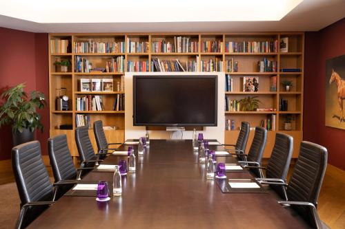 a conference room with a long table and chairs at INNSiDE by Meliá Dresden in Dresden