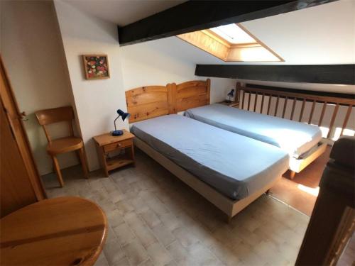 une chambre avec un grand lit et une chaise dans l'établissement Villa Face au Lac avec Terrasse et Barbecue - 3 Pièces + Mezzanine pour 6 Personnes - FR-1-81-96, à Port-Leucate