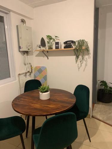 a table and chairs in a room at Confortable Apartaestudio in Bogotá