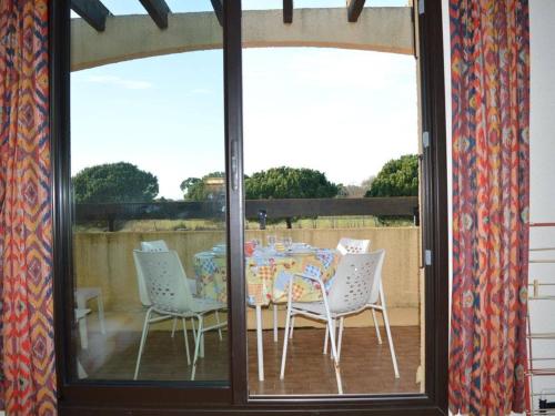 une table et des chaises assises sur une terrasse dans l'établissement Appartement 2 pièces avec terrasse, clim, parking, à 1300m de la plage - Saint-Cyprien Plage - FR-1-225D-169, à Saint Cyprien Plage