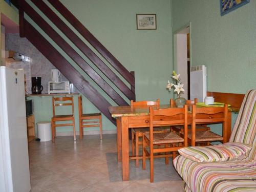 une salle à manger avec une table en bois et une cuisine dans l'établissement Maison avec jardin, véranda, parking, proche port et plage – 6 pers. à Saint-Cyprien - FR-1-225D-177, à Saint Cyprien Plage