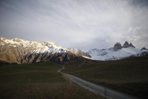 a road in front of a snow covered mountain at VVF Résidence Albiez-Montrond Maurienne in Albiez-Montrond