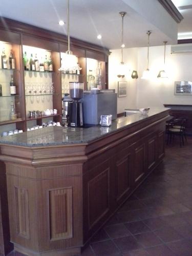 a kitchen with a large wooden counter in a restaurant at Albergo Italia di Nardi Renzo & C Snc in Poggibonsi