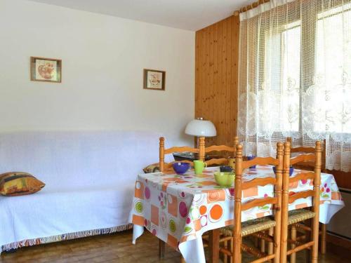 a room with a table with chairs and a bed at Appartement Le Grand-Bornand, 1 pièce, 5 personnes - FR-1-241-45 in Le Grand-Bornand