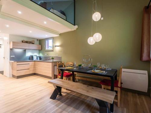 a kitchen and dining room with a table and a bench at Appartement Valmorel, 3 pièces, 7 personnes - FR-1-291-743 in Valmorel