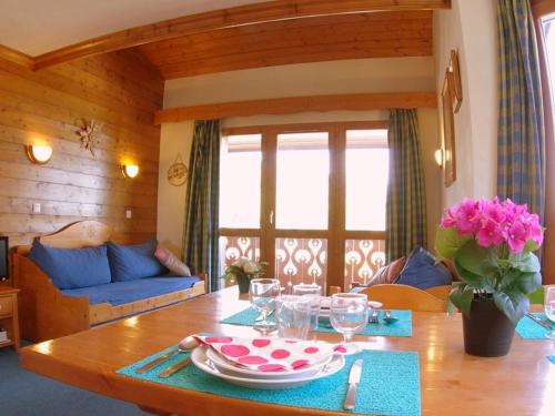 - un salon avec une table en bois et une table sidx sidx dans l'établissement Duplex 3P, 2 Chambres, Animaux OK, Casier à Skis, Valmorel - FR-1-291-728, à Valmorel