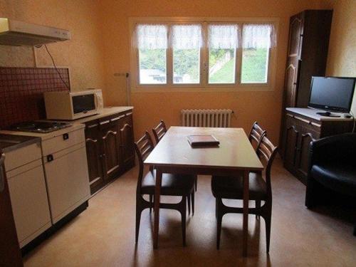 une cuisine avec une table et des chaises dans une pièce dans l'établissement Appartement 2 pièces avec WIFI gratuit, proche thermes et télécabine, parking et casier à skis - FR-1-234-118, à Cauterets
