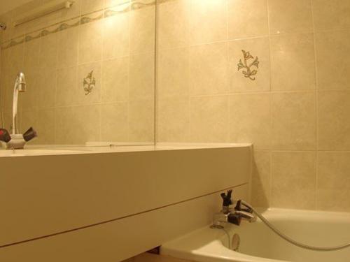 a bathroom with a sink and a shower and a tub at Appartement Valmorel, 2 pièces, 6 personnes - FR-1-291-764 in Valmorel