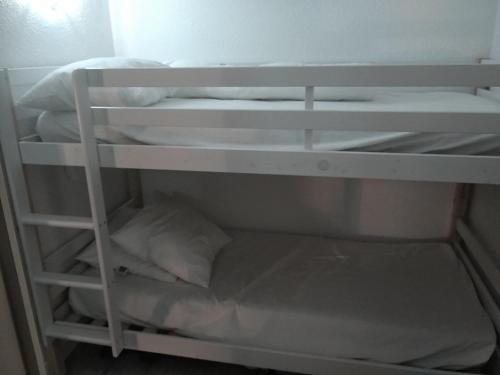 - un lit superposé blanc avec une étagère dans un dortoir dans l'établissement Studio Cauterets, 1 pièce, 4 personnes - FR-1-234-146, à Cauterets
