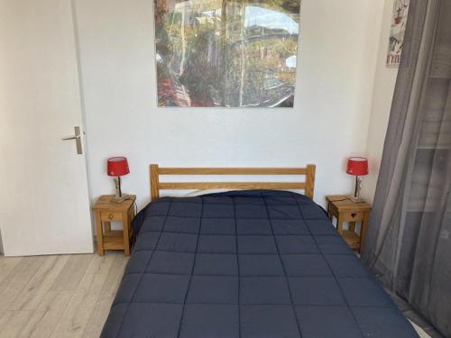 Ce lit se trouve dans un dortoir doté de 2 lampes sur les tables. dans l'établissement Charmant 2 pièces cabine avec véranda, terrasse exposée sud, proche des pistes et commerces, WiFi inclus - FR-1-262-76, à Forest des Baniols