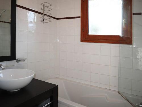 a bathroom with a sink and a tub and a window at Chalet Les Orres, 3 pièces, 6 personnes - FR-1-322-57 in Les Orres
