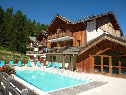 une maison avec une piscine devant dans l'établissement Chalet confortable avec piscine & sauna, aux pieds des pistes des Orres 1800, grand duplex pour 6 pers. - FR-1-322-57, aux Orres