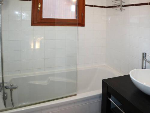 a white bathroom with a tub and a sink at Superbe chalet mitoyen avec piscine, sauna, hammam, près des pistes, Les Orres 1800 - FR-1-322-63 in Les Orres