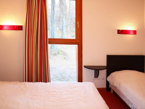 a room with two beds and a large window at Chalet Les Orres, 3 pièces, 6 personnes - FR-1-322-110 in Les Orres