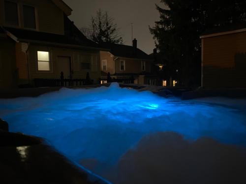 a blue light on a driveway at night at 1 Bus Stop To NYC-Hot Tub-EWR Airport-Free Parking in Hillside