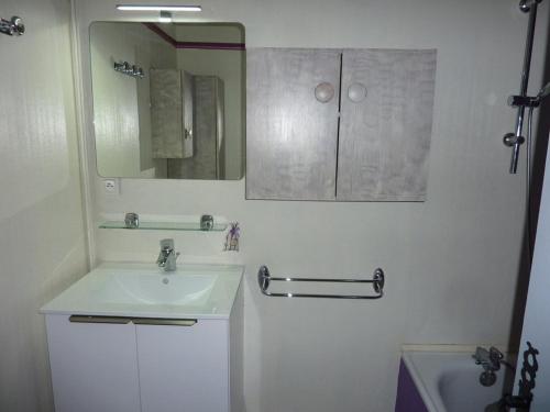 a bathroom with a sink and a mirror and a tub at Appartement Les Orres, 2 pièces, 6 personnes - FR-1-322-199 in Les Orres