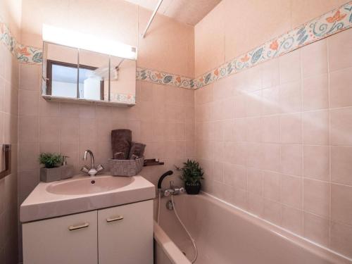 une salle de bain avec un lavabo et une baignoire dans l'établissement Appartement cosy pour 6 pers. avec balcon, proche centre et téléphérique, Saint Lary Village - FR-1-296-207, à Saint-Lary-Soulan