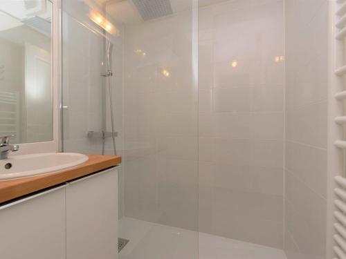 une salle de bain blanche avec une douche et un lavabo dans l'établissement Appartement Cosy 6 Pers à Saint Lary - Quartier Thermal - Proche Télécabine, Parking Privé - FR-1-296-216, à Saint-Lary-Soulan