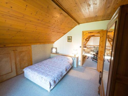 a bedroom with a bed and a wooden ceiling at Grande villa familiale à Briançon, 6 pièces, 14 pers., jardin, terrasse, parking couvert et wifi - FR-1-330C-71 in Briançon
