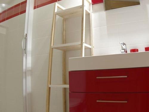 a bathroom with a ladder next to a red cabinet at Appartement Valmorel, 3 pièces, 6 personnes - FR-1-291-803 in Valmorel