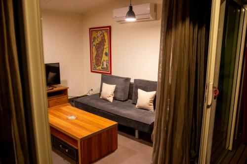a small living room with a couch and a television at Hotel La Villette in Antananarivo