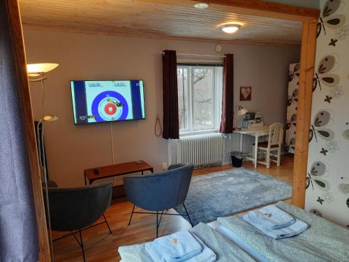 a living room with a flat screen tv on the wall at Geijersholms Herrgård in Hagfors