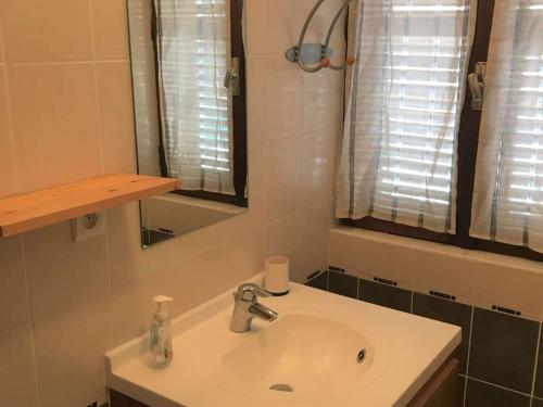 a bathroom with a white sink and a mirror at Appartement Briançon, 3 pièces, 8 personnes - FR-1-330C-84 in Briançon