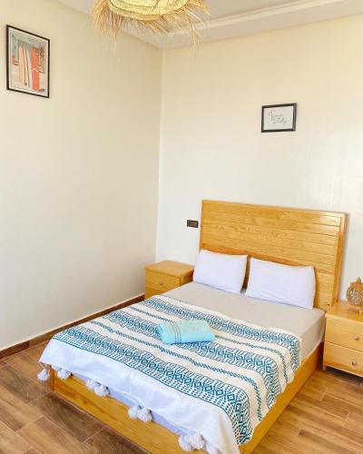 a bedroom with a bed and a chandelier at Imsouanegreenwave in Imsouane