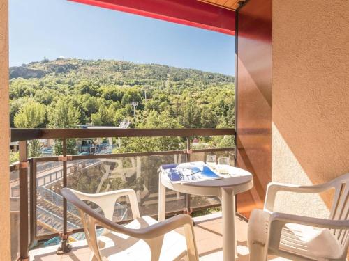 un balcon avec une table et des chaises et une vue dans l'établissement Studio cosy avec balcon, proche des pistes et du centre de Briançon, pour 2-4 personnes - FR-1-330C-41, à Briançon