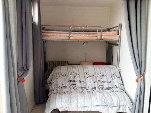 a bunk bed in a room with curtains at Studio Argelès-sur-Mer, 1 pièce, 3 personnes - FR-1-388-60 in Argelès-sur-Mer
