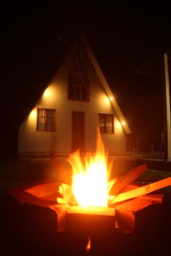 a fire pit in front of a house at night at Cabaña Alpina SEAL in Oxapampa