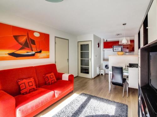 un salon avec un canapé rouge et une cuisine dans l'établissement Appartement cosy 6 pers avec wifi, parking et balcon à Barèges - FR-1-403-76, à Barèges