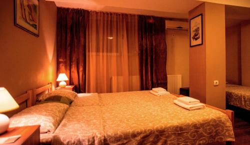 a hotel room with a bed with two towels on it at B&B Stadion in Belgrade