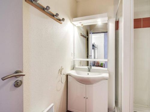 Baño blanco con lavabo y espejo en Appartement Cauterets, 2 pièces, 4 personnes - FR-1-401-7, en Cauterets