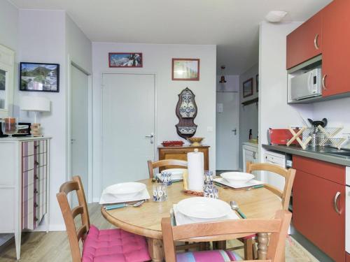 une cuisine avec une table en bois et des chaises ainsi qu'une salle à manger dans l'établissement Cauterets : Appartement cosy 4 pers, centre-ville, proche télécabine, parking ski inclus. - FR-1-401-16, à Cauterets
