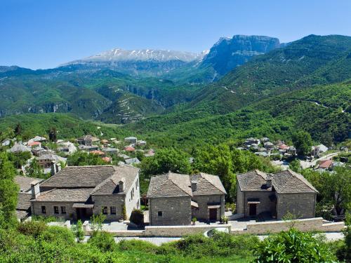 a group of houses in a valley with mountains at Aristi Mountain Resort in Aristi